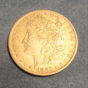 1883 O Morgan silver dollar.